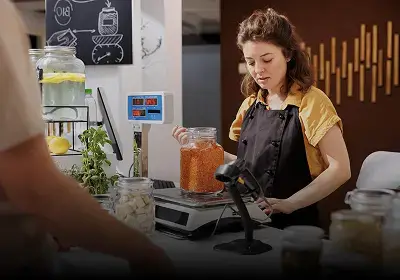 Retail billing POS system with cashier assisting customer